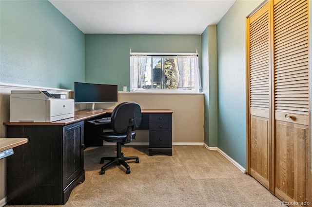 carpeted home office featuring baseboards