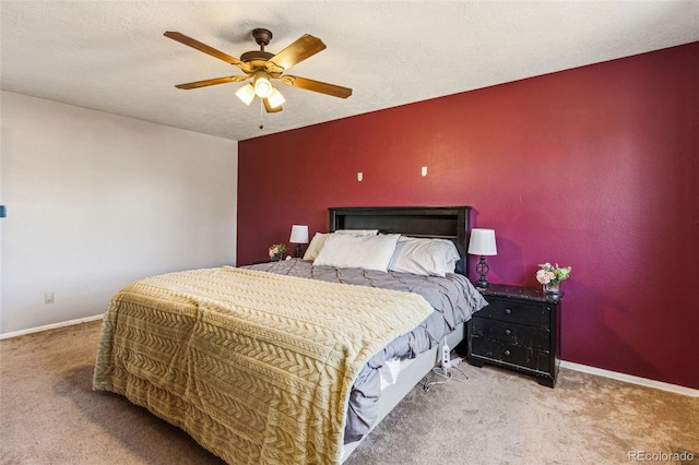 bedroom with carpet flooring, baseboards, and a textured ceiling