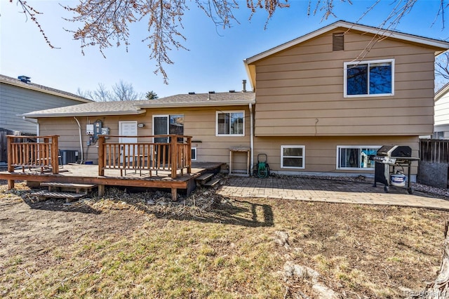 back of house with a patio area, central air condition unit, and a wooden deck