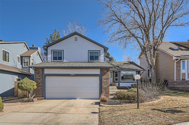 view of front of property with driveway, an attached garage, a shingled roof, and brick siding