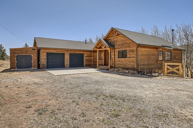 44 Forest Ridge Cir, Bailey, CO 80421 - rustic home with an attached garage and gravel driveway