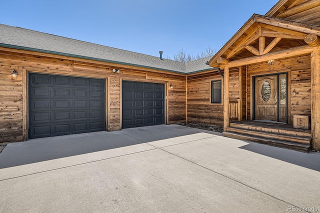 44 Forest Ridge Cir, Bailey, CO 80421 - doorway to property featuring driveway, a garage, and roof with shingles