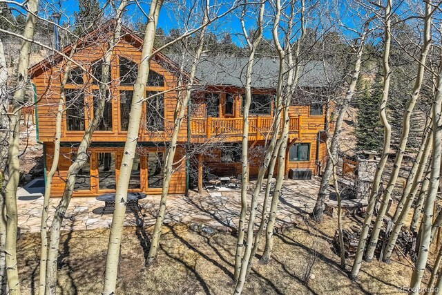 44 Forest Ridge Cir, Bailey, CO 80421 - rear view of house with a patio, a deck, and a shingled roof