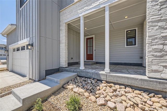 entrance to property featuring a porch and a garage