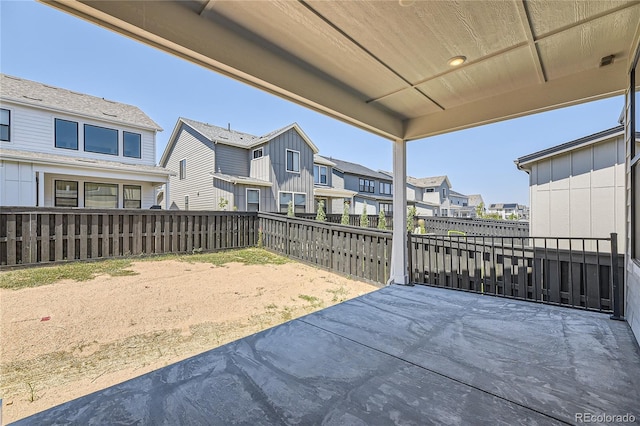 view of patio / terrace featuring a residential view and fence