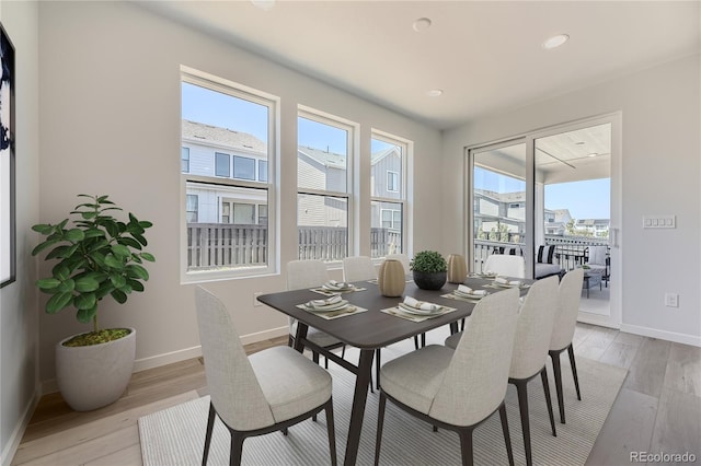 dining room with recessed lighting, light wood-type flooring, and baseboards