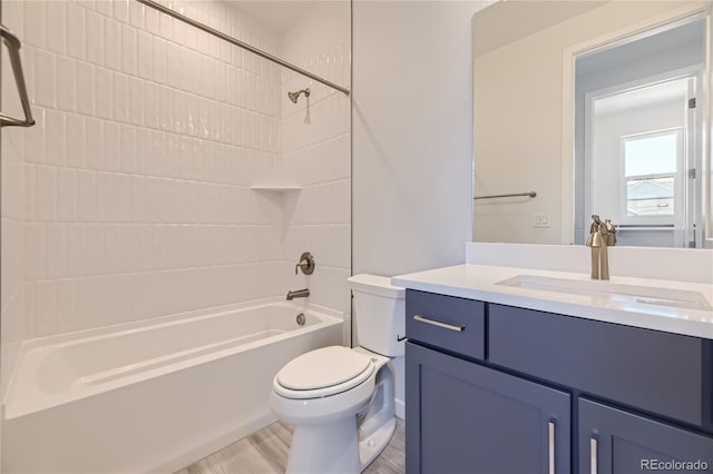 bathroom with toilet, bathtub / shower combination, wood finished floors, and vanity