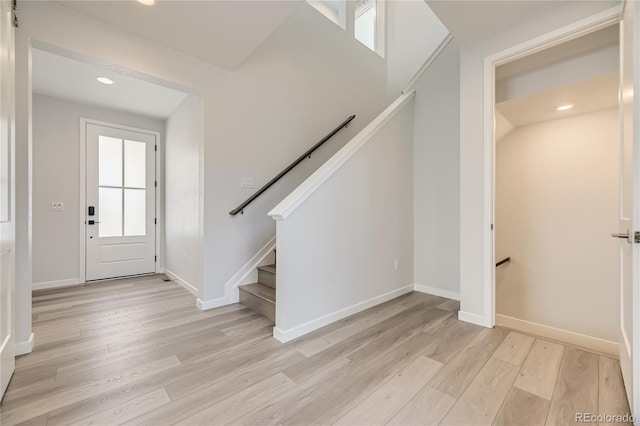 entrance foyer with light wood finished floors, plenty of natural light, recessed lighting, and baseboards