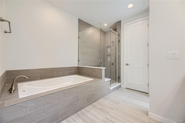 bathroom with a garden tub and a shower stall