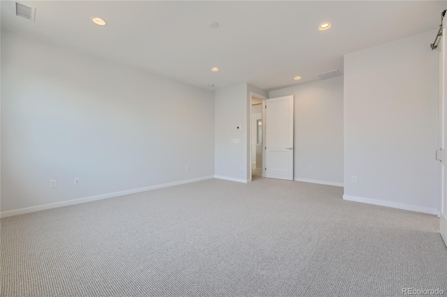 unfurnished room with light colored carpet