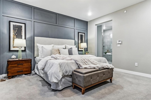 carpeted bedroom featuring ensuite bath