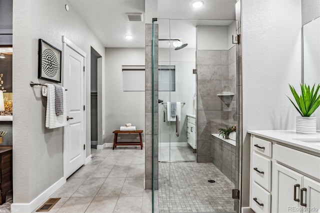 bathroom with tile patterned flooring, vanity, and a shower with shower door