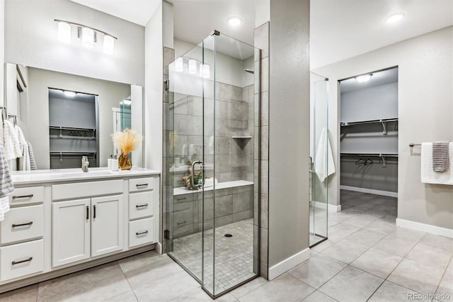 bathroom with tile patterned floors, vanity, and an enclosed shower