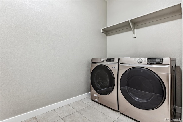 washroom with light tile patterned flooring and separate washer and dryer