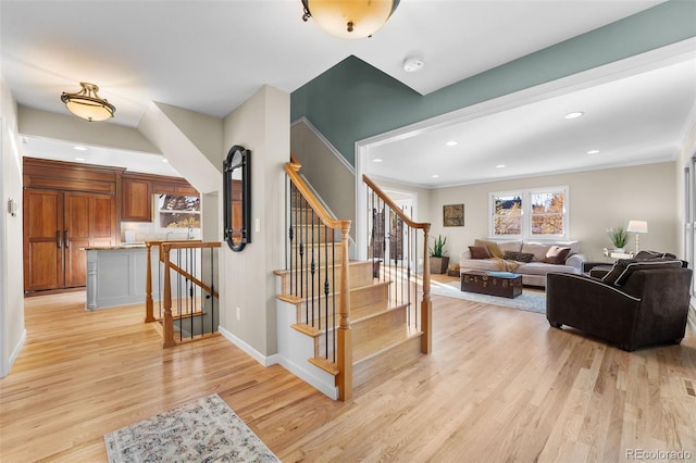 stairway featuring crown molding and hardwood / wood-style floors