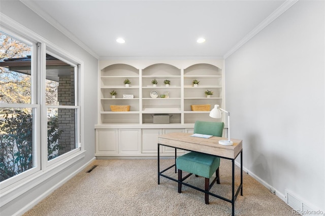 carpeted office space with ornamental molding and built in shelves