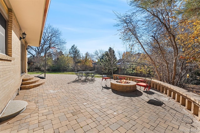 view of patio / terrace featuring an outdoor fire pit