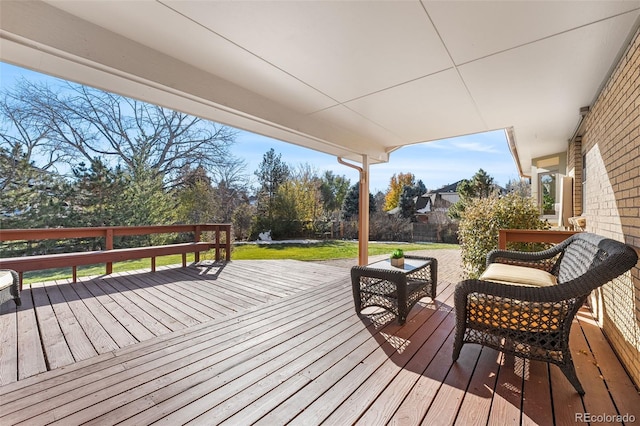 wooden deck featuring a lawn