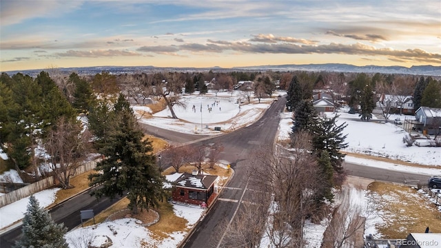 snowy aerial view with a mountain view