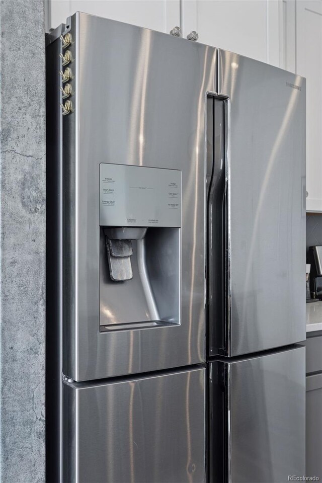 25106 E 1st Ave, Aurora, CO 80018 - kitchen view of stainless steel fridge with ice dispenser and white cabinetry