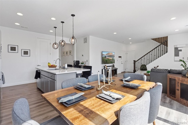 25106 E 1st Ave, Aurora, CO 80018 - dining space featuring recessed lighting, stairway, and wood finished floors