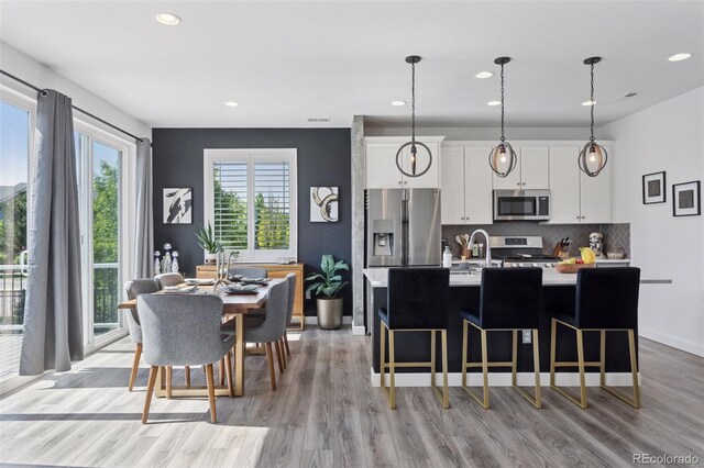 25106 E 1st Ave, Aurora, CO 80018 - dining area with light wood finished floors and recessed lighting