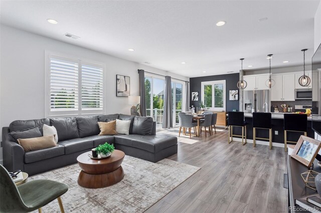 25106 E 1st Ave, Aurora, CO 80018 - living area with recessed lighting and light wood-style floors