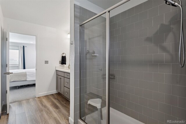 25106 E 1st Ave, Aurora, CO 80018 - full bath featuring a shower stall, wood finished floors, vanity, and ensuite bath
