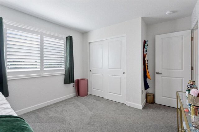 25106 E 1st Ave, Aurora, CO 80018 - carpeted bedroom featuring baseboards and a closet