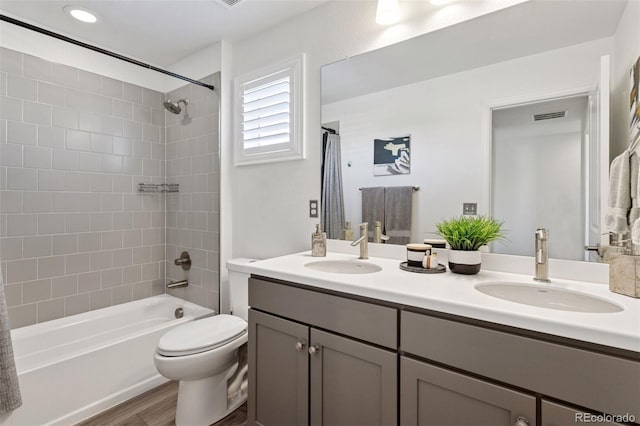 25106 E 1st Ave, Aurora, CO 80018 - bathroom with double vanity, bathing tub / shower combination, and wood finished floors