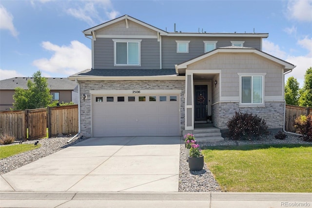 25106 E 1st Ave, Aurora, CO 80018 - view of front facade featuring stone siding, driveway, and a garage
