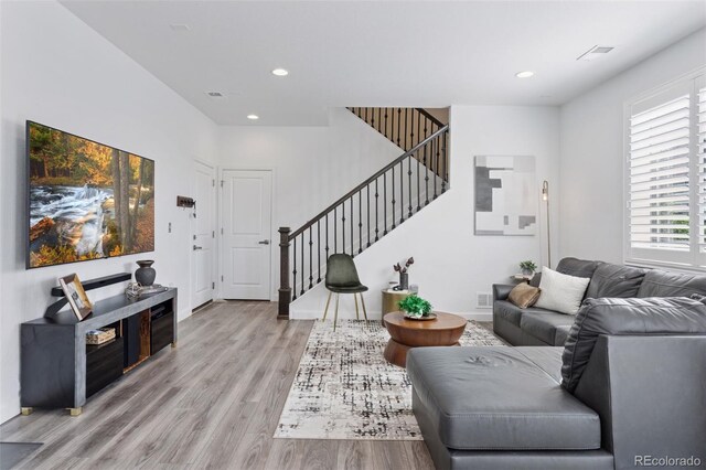 25106 E 1st Ave, Aurora, CO 80018 - living room featuring stairway, light wood-type flooring, and recessed lighting
