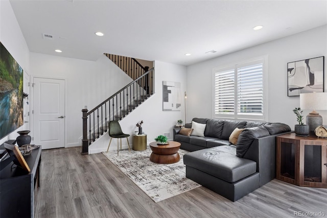 25106 E 1st Ave, Aurora, CO 80018 - living area with wood finished floors, stairway, and recessed lighting