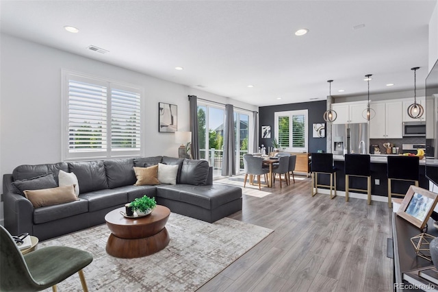 25106 E 1st Ave, Aurora, CO 80018 - living room with recessed lighting and light wood-style flooring