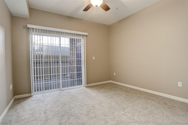 carpeted spare room with ceiling fan