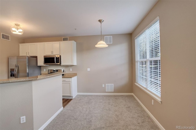 kitchen with light stone countertops, white cabinetry, stainless steel appliances, light colored carpet, and decorative light fixtures