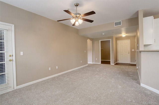 unfurnished living room featuring light colored carpet and ceiling fan