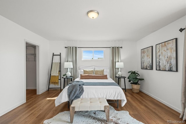 2845 Cherry Way, Parker, CO 80138 - bedroom with wood finished floors and a walk in closet