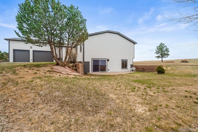 2845 Cherry Way, Parker, CO 80138 - back of property featuring a garage, a patio area, and a yard