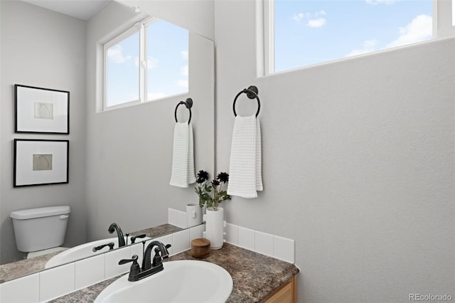 bathroom featuring toilet and vanity