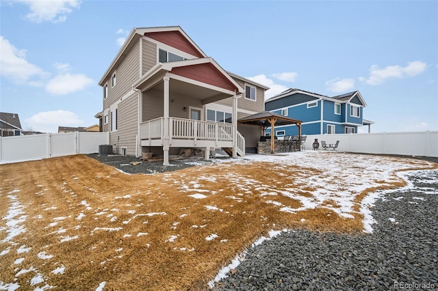 snow covered property featuring central AC unit and a gazebo