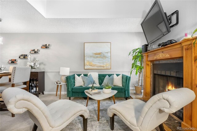 5155 W 68th Ave Unit 5, Westminster, CO 80030 - living area featuring a textured ceiling, a warm lit fireplace, and baseboards