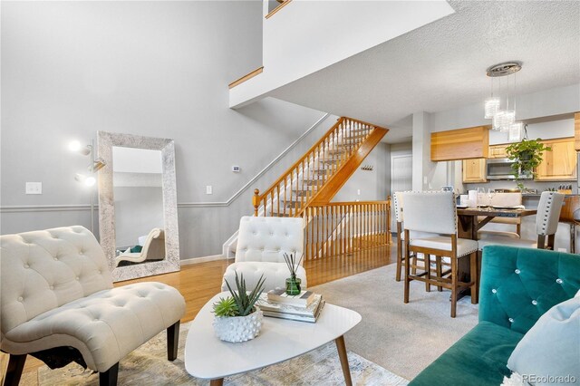 5155 W 68th Ave Unit 5, Westminster, CO 80030 - living area featuring stairway, baseboards, and a textured ceiling