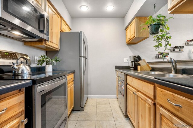 5155 W 68th Ave Unit 5, Westminster, CO 80030 - kitchen with stainless steel appliances, dark countertops, a sink, baseboards, and light tile patterned flooring