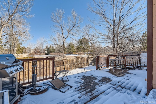 snow covered deck featuring area for grilling