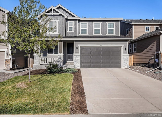 1011 White Leaf Cir, Castle Rock, CO 80108 - craftsman-style home featuring covered porch, concrete driveway, a front yard, an attached garage, and stone siding