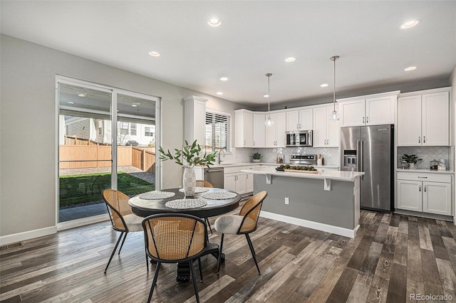 1011 White Leaf Cir, Castle Rock, CO 80108 - kitchen featuring appliances with stainless steel finishes, light countertops, tasteful backsplash, a sink, and white cabinetry