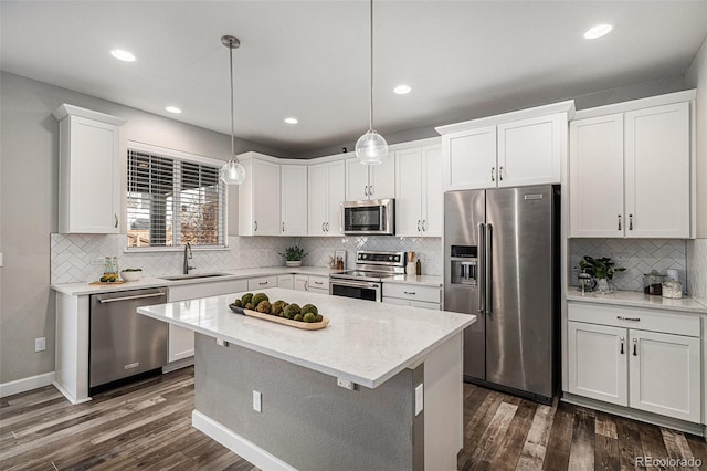 1011 White Leaf Cir, Castle Rock, CO 80108 - kitchen featuring appliances with stainless steel finishes, a sink, backsplash, dark wood finished floors, and white cabinetry
