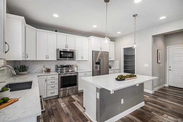 1011 White Leaf Cir, Castle Rock, CO 80108 - kitchen featuring stainless steel appliances, a sink, dark wood-style floors, tasteful backsplash, and white cabinetry