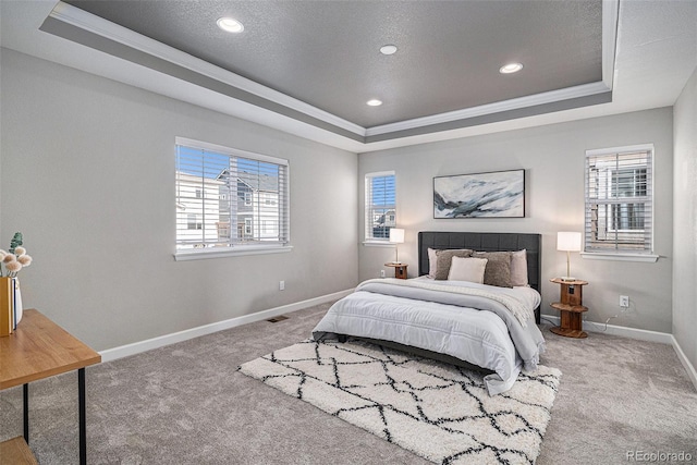 1011 White Leaf Cir, Castle Rock, CO 80108 - carpeted bedroom with a raised ceiling, multiple windows, baseboards, a textured ceiling, and ornamental molding